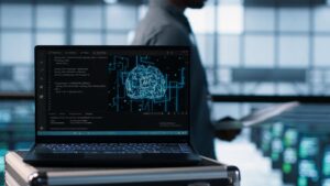 Laptop screen displaying code and a glowing digital brain graphic inside a server room, visually explaining the concept of what is AIOps.